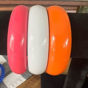 Orange, pink, and white bracelets